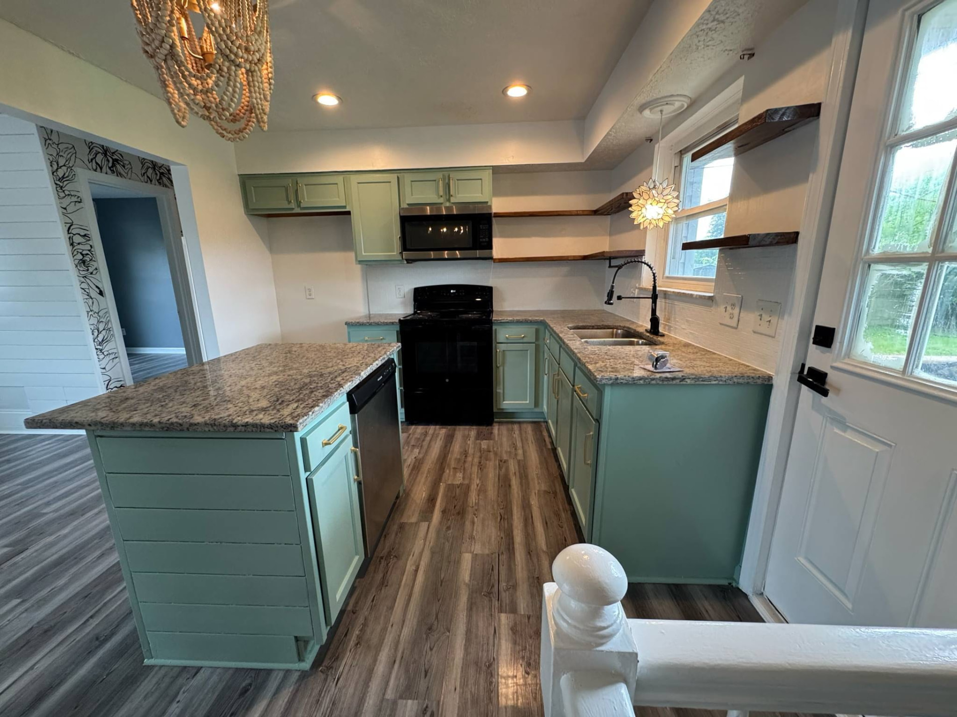 Grey plank flooring running through the open-plan kitchen and dining area