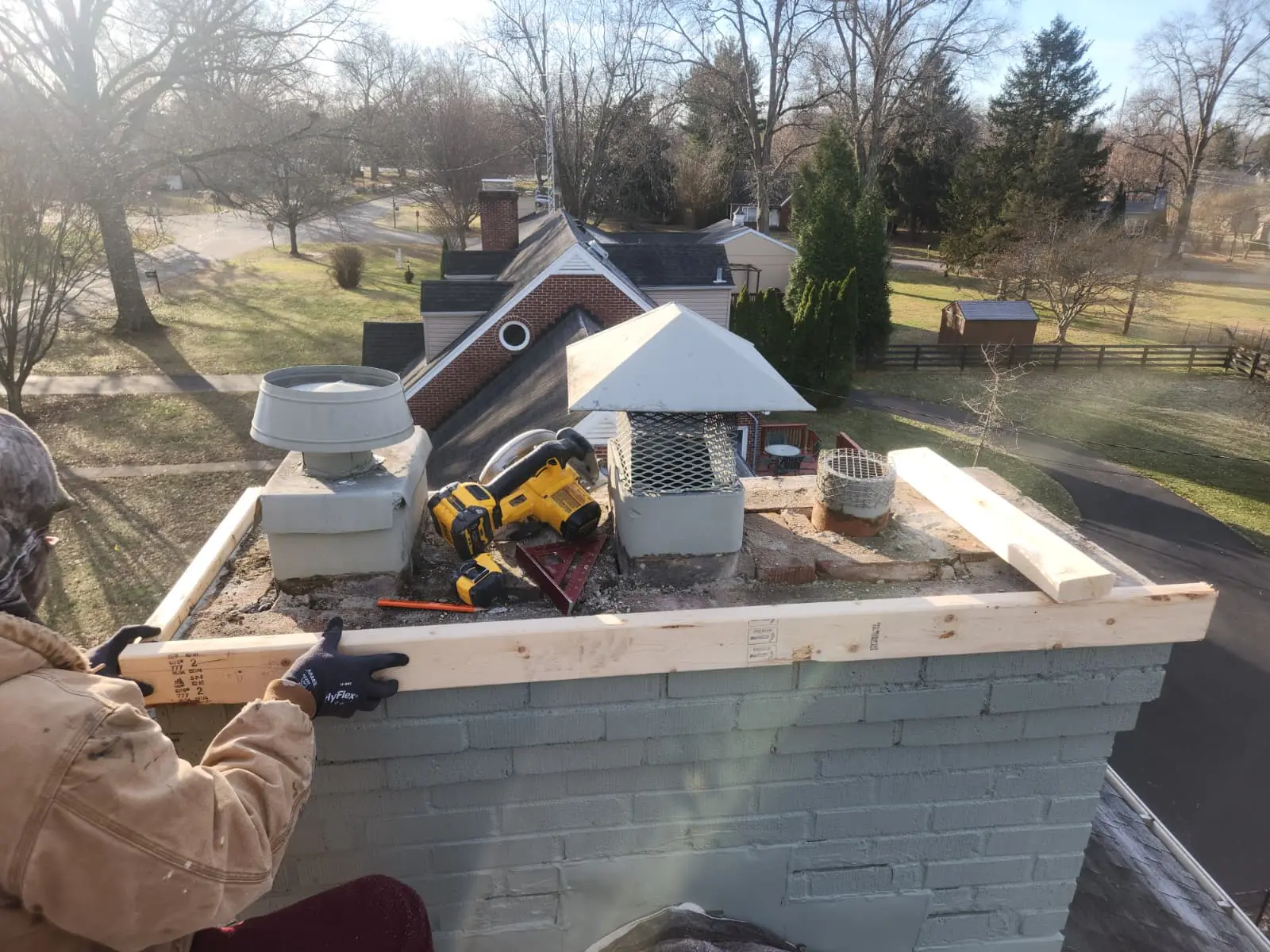 New timber formwork set on a painted brick chimney ready for a fresh concrete crown pour